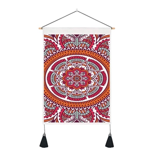 Detail of bohemian mandala tapestry featuring intricate patterns, wooden pole and black tassels