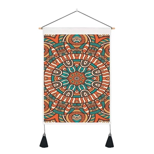 Vertical mandala tapestry with warm orange patterns, wooden rod and black side tassels