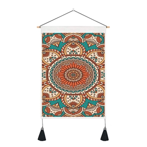 Detail of bohemian mandala tapestry with wooden hanging rod and black tassels