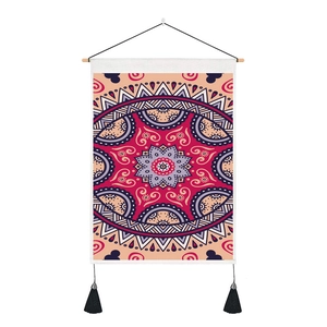 Detail of bohemian mandala tapestry with wooden hanging rod and black decorative tassels