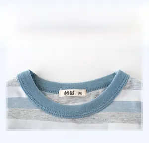 Close-up of blue ribbed neckline on striped cotton kids T-shirt with neat stitching