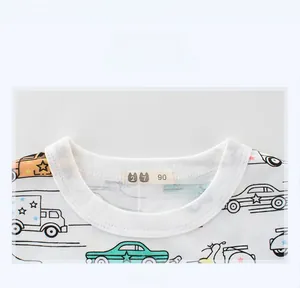 Close-up detail of soft knit cotton neckline with colorful cartoon car and star patterns