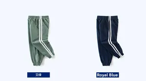 Detail view of sage green and royal blue cotton sweatpants with sporty side stripes