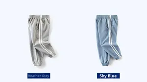 Detail of boys joggers in heather grey and light blue with side stripes and ribbed cuffs