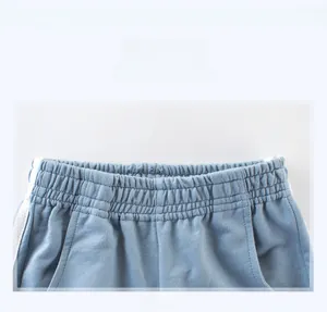 Detail of light blue boys joggers showing elastic waistband and soft fleece texture