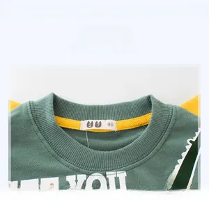 Close-up of ribbed neckline and fabric detail on dark green dinosaur kids sweatshirt