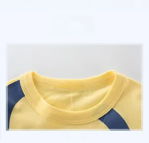 Close-up of the ribbed crew neck and size label on this yellow cotton t-shirt for boys