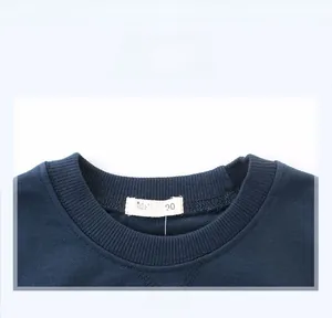 Close-up of neckline and size label on deep blue cotton crewneck sweatshirt for boys