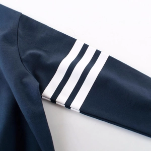 Kids navy crewneck sweatshirt sleeve detail featuring three white decorative stripes