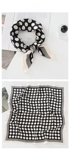 Detailed view of polka dot silk scarf with striped edges and smooth satin texture
