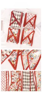 Detailed views of four printed silk scarves featuring red borders and artistic patterns