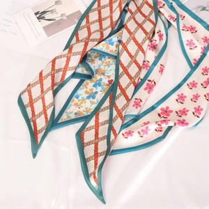 Detail of floral and geometric pattern satin scarf for hair styling or bag decoration