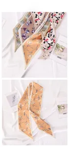 Detailed tile display of various long floral and leopard print satin silk scarves on white silk