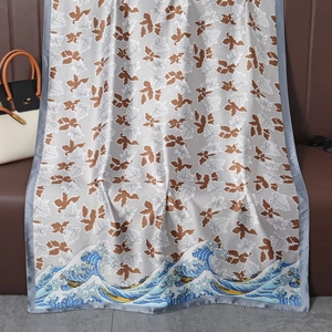 Detail of silk-like grey scarf featuring vintage leaf prints and ukiyo-e wave patterns