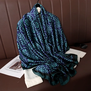 Vintage floral silk satin scarf in deep blue and green draped over a white shirt