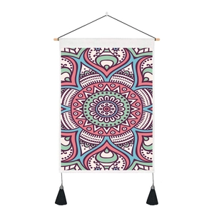 Detail of bohemian mandala tapestry with wooden pole and black tassel accents