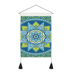 Detail of bohemian mandala tapestry with wooden pole, blue-green geometric print and tassels
