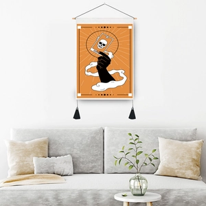 Death Tarot card tapestry with wooden pole and black tassels hanging above a modern sofa
