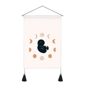 Detailed view of galaxy baby tapestry with crescent moon phases and decorative black tassels