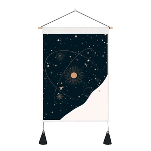 Detail of the astronomy wall tapestry with celestial star patterns and black tassels