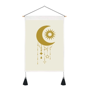 Bohemian wall tapestry with sun moon design, wooden rod and black tassel detail