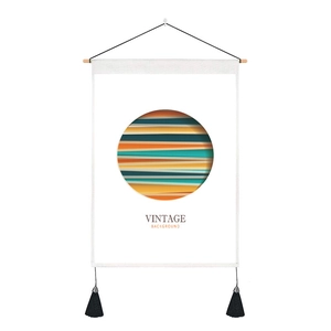 Detail of vintage wall tapestry with geometric prints, wood rod, and black tassels decor