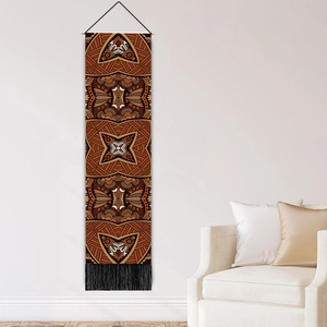 Bohemian mandala tapestry with geometric tribal patterns and black tassels on white wall