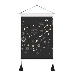Close-up of black tarot tapestry with wooden hanger and mystical celestial pattern