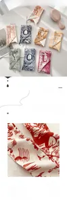 Macro detail of pleated silk scarf texture and high-quality printed typography pattern