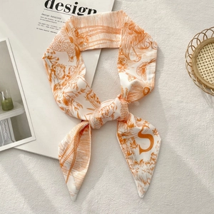 Detail of white and orange floral twilly silk scarf with hand-drawn lion print and S logo