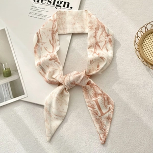 Detailed shot of orange Toile de Jouy floral pattern on premium satin skinny scarf