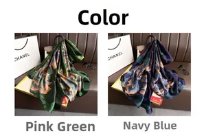 Detail of premium satin scarves with large floral patterns in pink green and navy blue