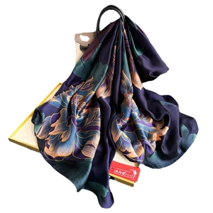 Deep purple faux silk scarf with lotus print styled on a beige bag and gift box