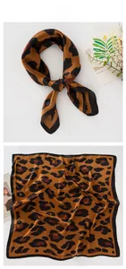 Detailed tile display of a leopard print silk-satin square scarf with elegant props