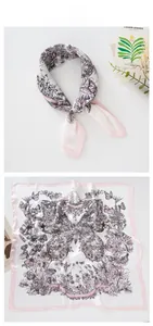 Flat lay of silk scarf with elegant butterfly floral prints and soft pink borders