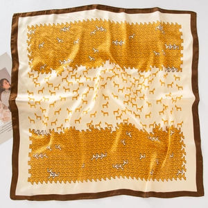 Detail view of square satin scarf with yellow geometric horse print and dark brown border
