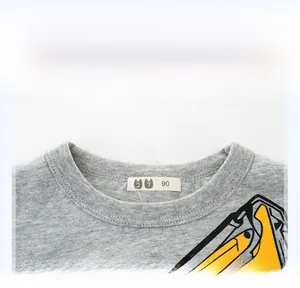 Detail of grey cotton crew neck kids T-shirt with ribbed collar and yellow graphics