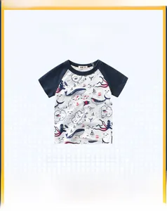 Detail of navy boy's T-shirt featuring nautical whale and pirate ship illustrations