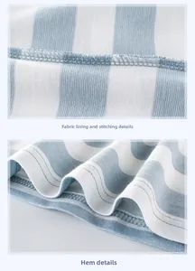 Detail of inner stitching and hem on blue and white striped cotton fabric for kids