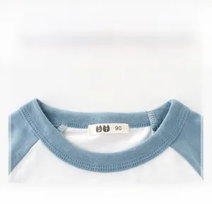 Close-up of ribbed neckline and blue raglan sleeve detail on cotton kids T-shirt