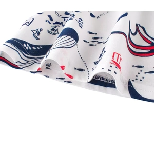Boy's white cotton T-shirt featuring nautical prints of sailboats and whales on the hem