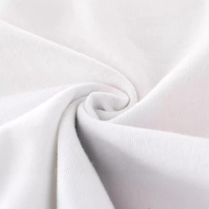 Close-up of soft white knitted cotton fabric texture for boys cartoon t-shirt