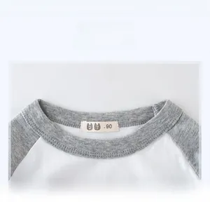 Macro detail of kids' grey and white round neck sweatshirt with size 90 label