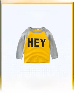 Detail of yellow and grey kids' raglan sleeve T-shirt with 'HEY' letter print and soft cotton fabric