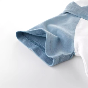 Close-up of ribbed cuffs on light blue and white short sleeve t-shirt for boys