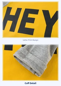 Detail of yellow cotton kids T-shirt with HEY print and grey stitched sleeve cuff