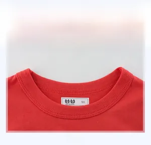Close-up of red cotton knit T-shirt neckline with 27 KIDS size 90 brand label