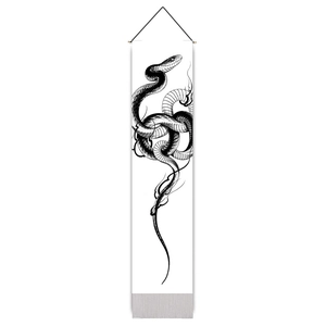 Detail of a monochrome snake print wall scroll with tassels and a black hanging rope