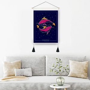Pisces zodiac tapestry wall hanging with blue starry sky and tassels on white wall