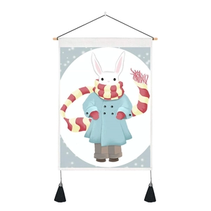 Detailed view of canvas tapestry with rabbit illustration and black fringe tassels